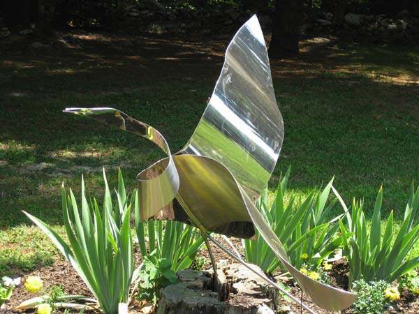 a custom sign placed in a small garden