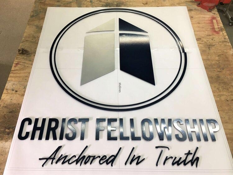 a custom sign that reads "Christ Fellowship — Anchored in Truth"