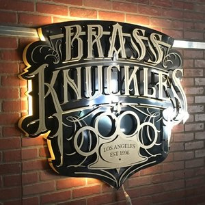 Brass Knuckles backlit sign