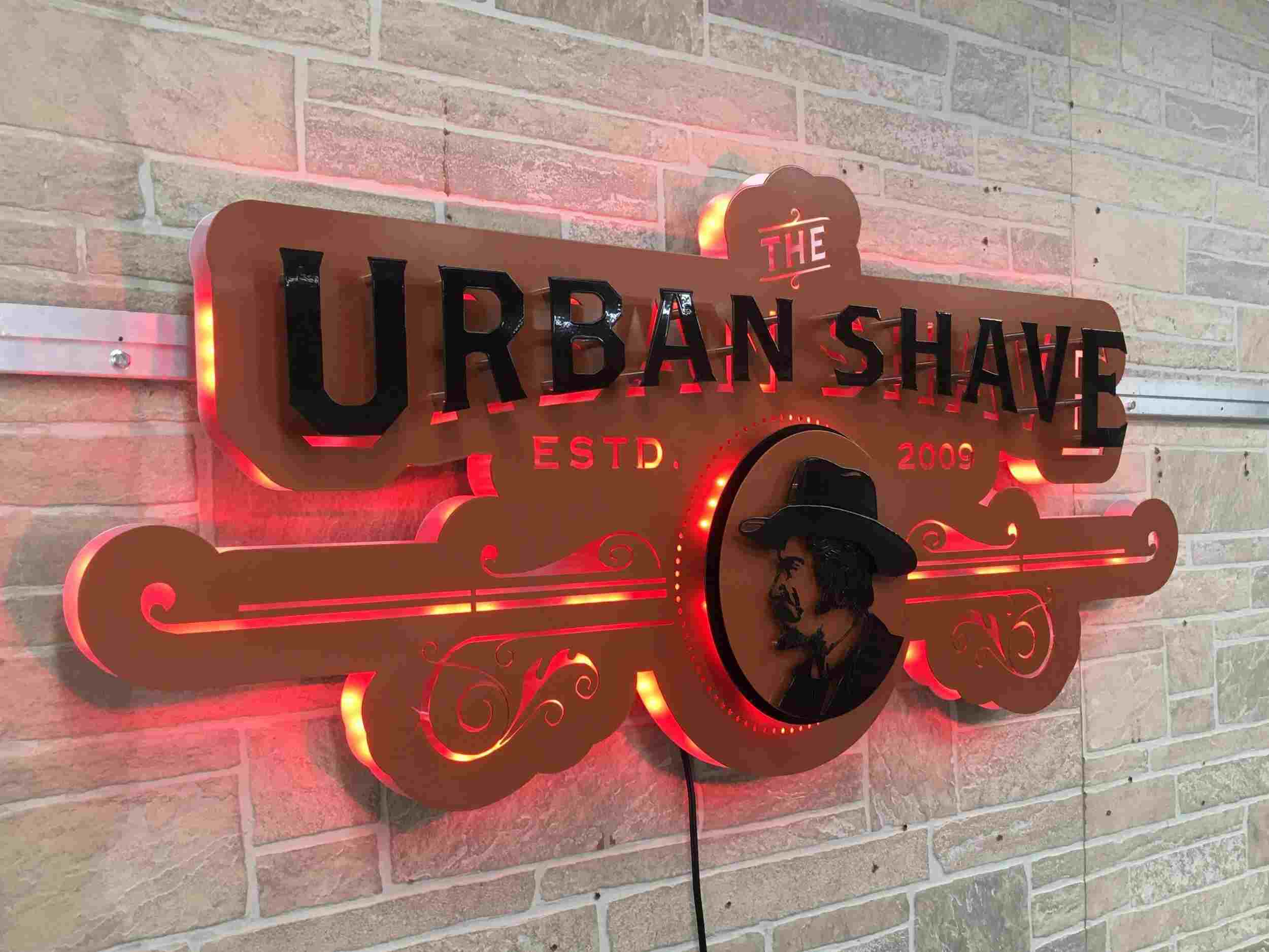 Copper Urban Shave sign with red backlighting