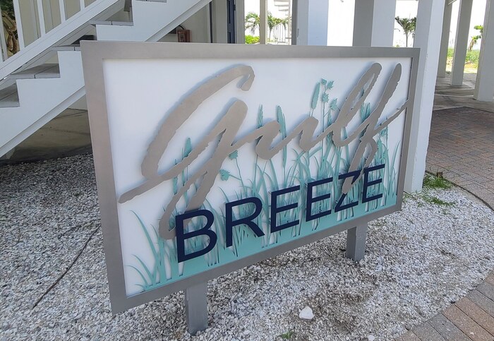 Gulf Breeze Monument Outdoor Sign by a set of stairs