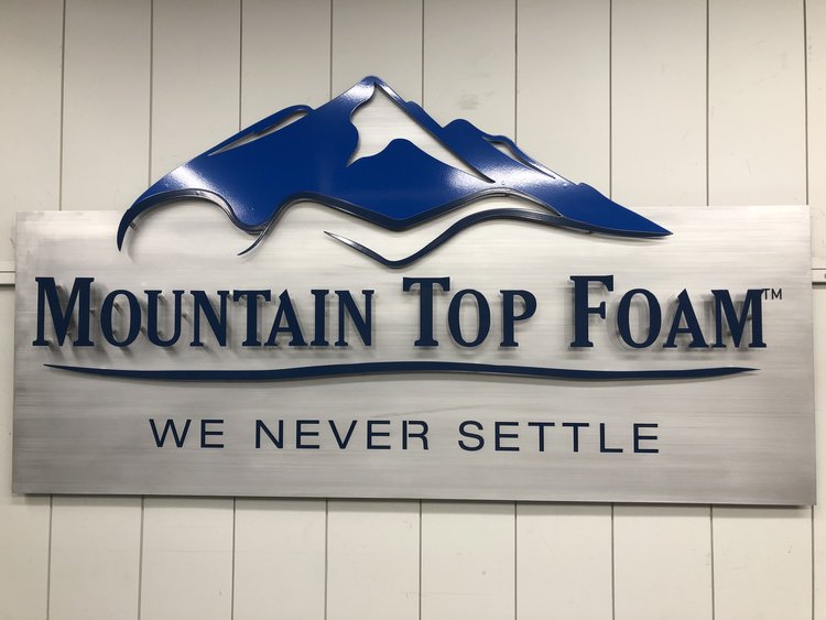 steel mountain top foam custom office sign with the slogan we never settle