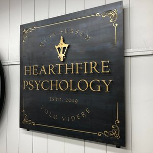 a custom designed metal sign for Hearthfire Psychology