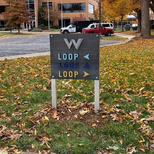 a custom metal sign meant for directing parking lot traffic