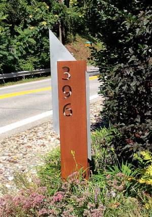 a custom outdoor sign in the ground with the number 396