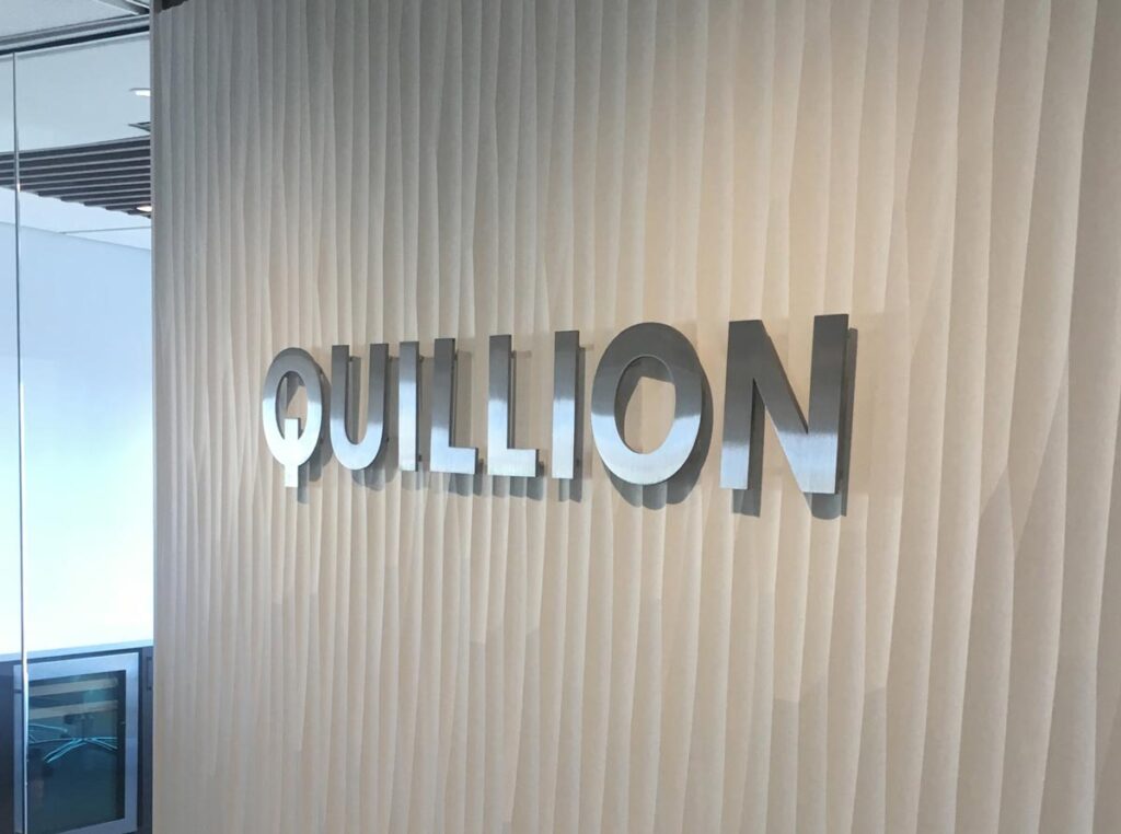 a freestanding pylon sign inside an office lobby