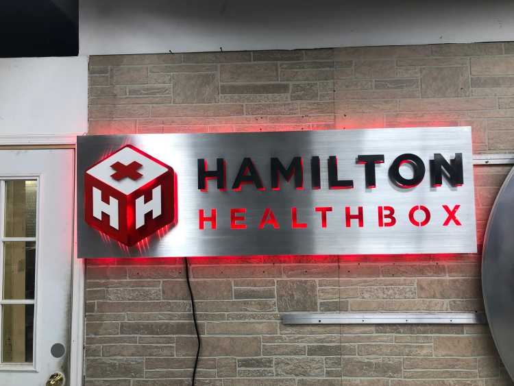 illuminated custom sign for the hamilton healthbox in brushed aluminum