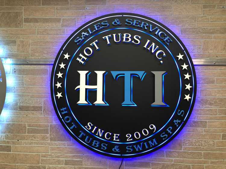 custom multi layered illuminated sign for the hot tubs incorporated shop