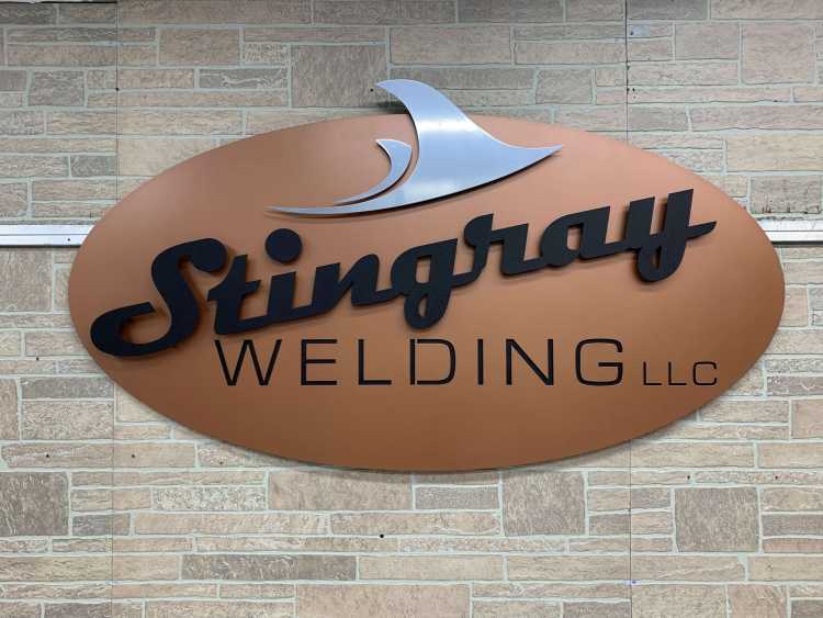 finished custom stingray welding llc sign with copper and steel elements