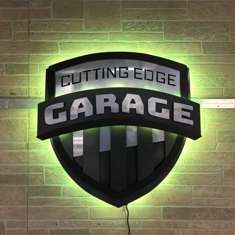 custom illuminated sign for the cutting edge garage