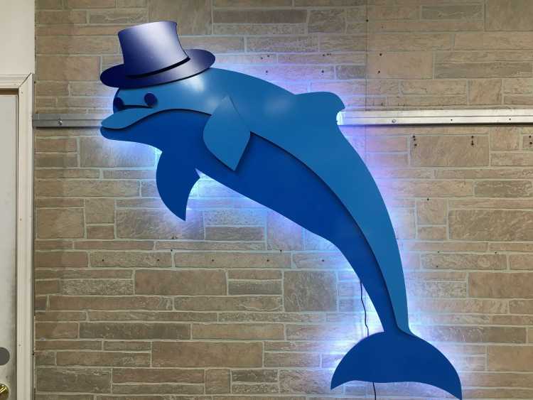 illuminated custom sign of a dolphin wearing a top hat