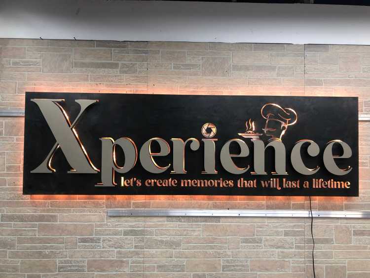 illuminated custom sign for the xperience bakery with a blued steel powder coating finish